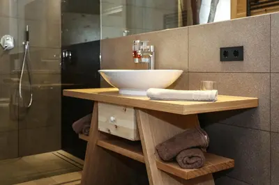 a bathroom with a sink and a shower at Hotel Gasthof Höllriegl in Sarntal