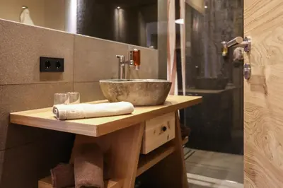 a bathroom with a sink and a shower at Hotel Gasthof Höllriegl in Sarntal