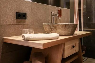 a bathroom with a sink and a bowl on a counter at Hotel Gasthof Höllriegl in Sarntal