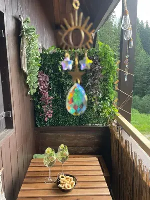 a table with two wine glasses and a bowl of food at Splendida Carezza in Carezza al Lago