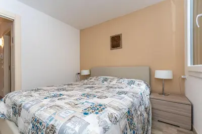a bedroom with a bed with a quilt on it at Casa Baranci in Pozza di Fassa