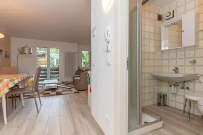 a kitchen and dining room with a sink and a table at Casa Baranci in Pozza di Fassa