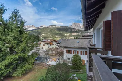a view from a balcony of a town with mountains at Casa Baranci in Pozza di Fassa