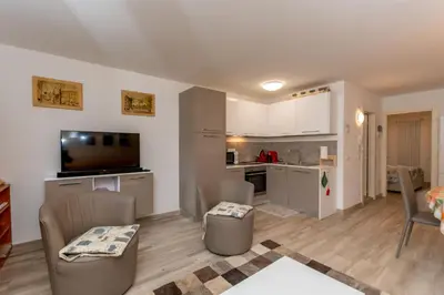 a small living room with a kitchen and a living room at Casa Baranci in Pozza di Fassa