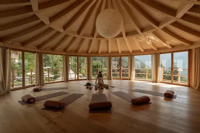 a woman in a room with a lot of yoga mats at Alma Apartments in Luson