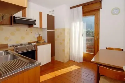 a kitchen with a sink and a stove top oven at CASA PINUCCIA MANSARDA in Predazzo