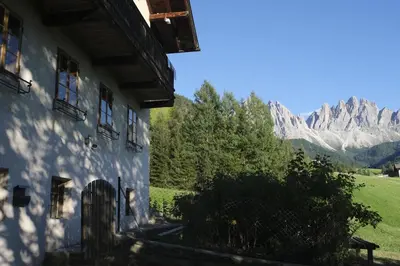 a building with a view of the mountains at Farmhouse with a stunning view over the dolomites in Villnoss