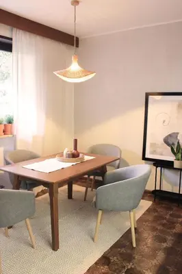 a dining room with a wooden table and chairs at haus e Apartment 1 in Lana