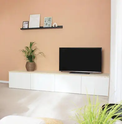a television on a white cabinet in a living room at haus e Apartment 1 in Lana