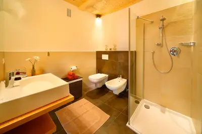 a bathroom with a sink and a shower and a toilet at Beimsteinhof in Verano