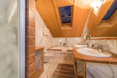 a bathroom with a sink and a shower at Lusina Apartments in Luson