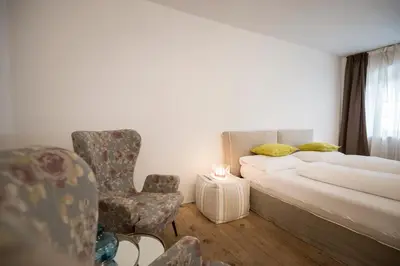 a lamp sitting next to a bed with a pillow at Gius La Diffusa in Caldaro