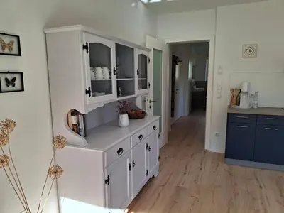a kitchen with a large white cabinet in a room at Haus Hafner Sonniges Apartment in Terlano
