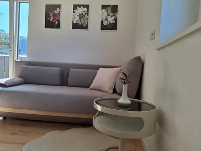 a living room with a couch and a table at Haus Hafner Sonniges Apartment in Terlano