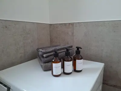three bottles sitting on top of a white counter at Haus Hafner Sonniges Apartment in Terlano