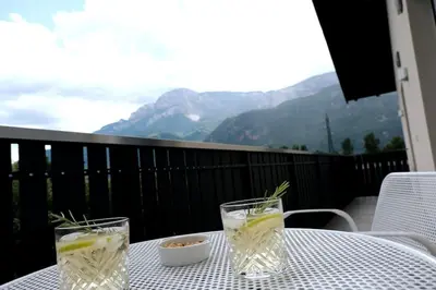 a table with two glasses of water and a bowl of food at Haus Hafner Sonniges Apartment in Terlano