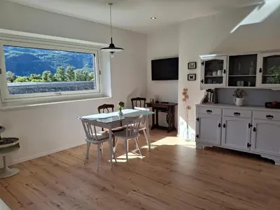 a kitchen and dining room with a table and a window at Haus Hafner Sonniges Apartment in Terlano
