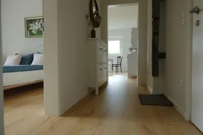 a living room with a bed and a wooden floor at Haus Hafner Sonniges Apartment in Terlano