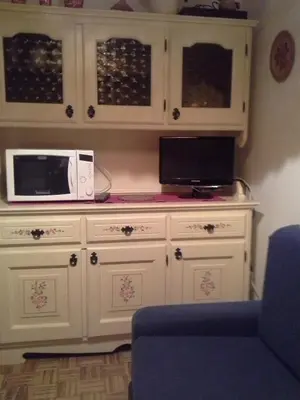 a white cabinet with a microwave on top of it at Appartamento Niki Campitello in Campitello di Fassa