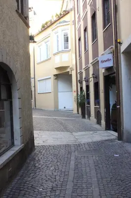 a cobblestone street in a city with buildings at Loft l'Alessandra in Bolzano