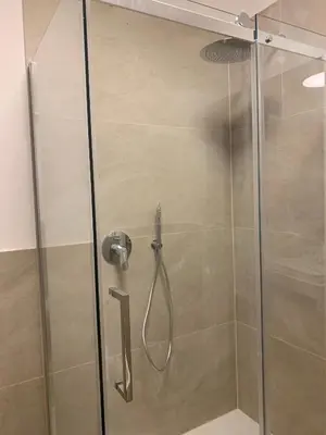 a shower with a glass door in a bathroom at Loft l'Alessandra in Bolzano