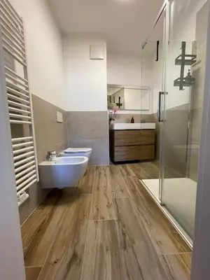 a bathroom with a sink and a toilet and a shower at Loft l'Alessandra in Bolzano