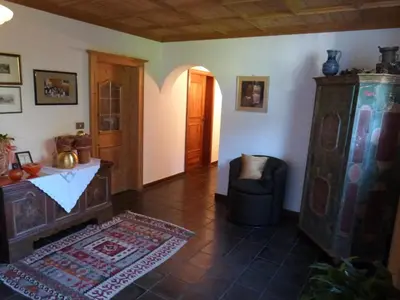 a living room with a couch a chair and a table at Pension Riedingerhof in Merano