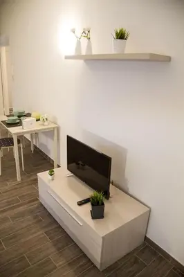 a living room with a flat screen tv on a table at Apartments Fewo in Bolzano