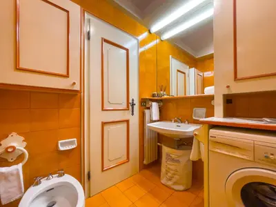 a small bathroom with a toilet and a sink at I cuori in Cortina dʼAmpezzo