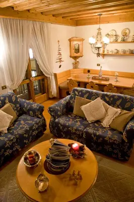 a living room with a couch and a table at I cuori in Cortina dʼAmpezzo