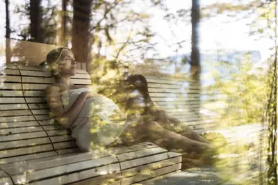 a statue of a woman sitting on a bench at AKI Family Resort PLOSE in Bressanone