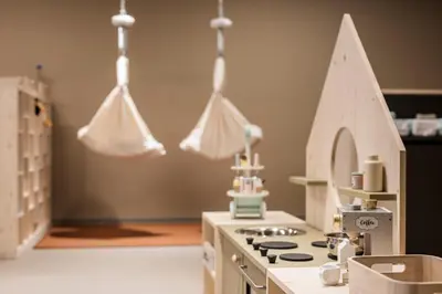 a kitchen with a toy kitchen with a toy house at AKI Family Resort PLOSE in Bressanone