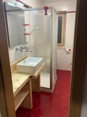 a bathroom with a sink and a shower at CASA BAMBA in Tesero