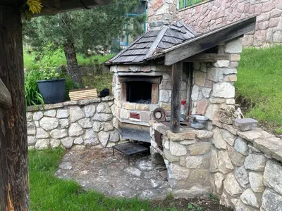an outdoor oven in a stone wall at CASA BAMBA in Tesero