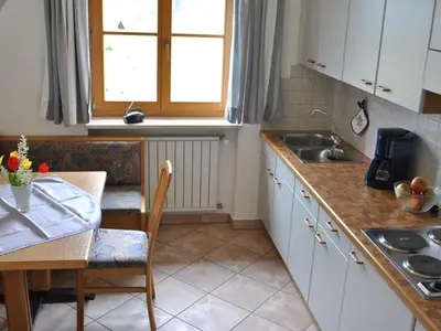 a kitchen with a table and a sink and a table and a tablektop at Rastenfeldhof in Parcines