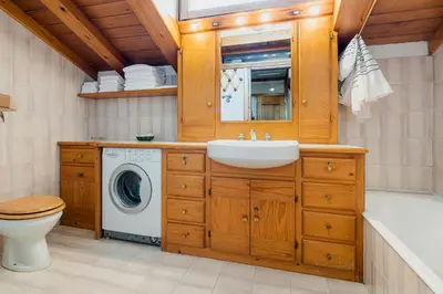 a bathroom with a sink and a washing machine at Appartamenti Pagan in San Vito di Cadore