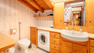 a bathroom with a sink and a washing machine at Appartamenti Pagan in San Vito di Cadore