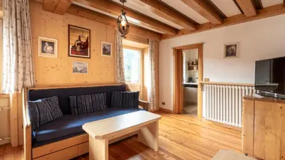 a living room with a couch and a tv at Appartamenti Pagan in San Vito di Cadore