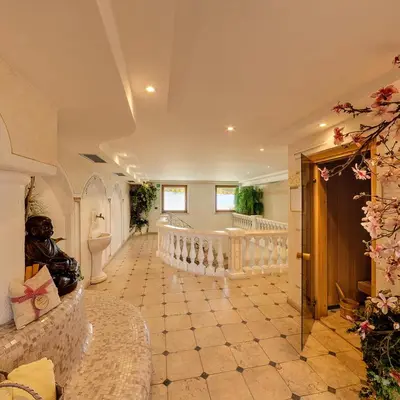 a large room with a hallway with a staircase and a room with aocrates at Hotel Tonnerhof in Racines