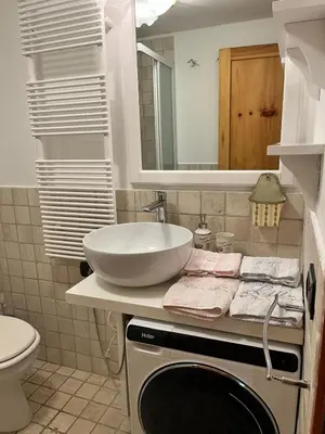 a bathroom with a sink and a counter with a sink at Appartamento Al Laghetto in San Martino di Castrozza