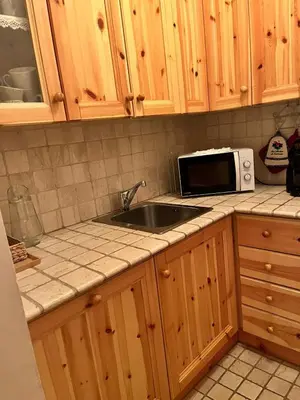 a kitchen with a sink and a microwave at Appartamento Al Laghetto in San Martino di Castrozza
