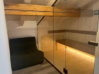 a room with a chair and a glass wall at Wolter Landhaus in Vipiteno
