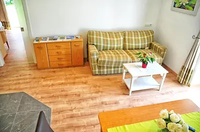 a living room with a couch and a table at Lindenhof Residence Meran in Merano