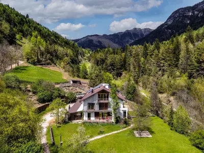 an aerial view of a house in the mountains at Agritur Artemisia in Tesero