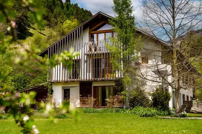 a large white house with a balcony at Agritur Artemisia in Tesero
