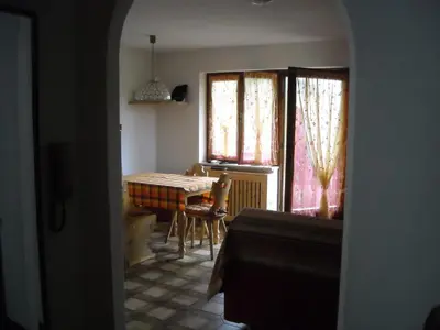 a dining room with a table and a table and chairs at Casa Erica - Carano in Carano
