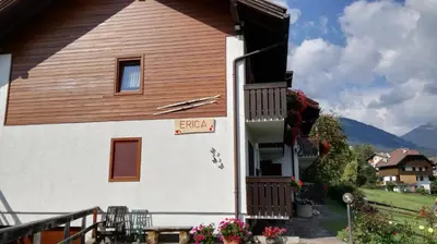 a house with a sign on the side of it at Casa Erica - Carano in Carano