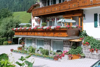a building with flowers on the side of it at Albergo Trentino in Moena