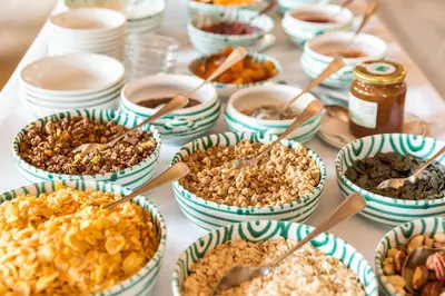 a table topped with bowls of different types of food at Gasthof zur Krone in Aldino
