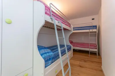a room with two bunk beds in a room at La Casa di Sofia in Alleghe